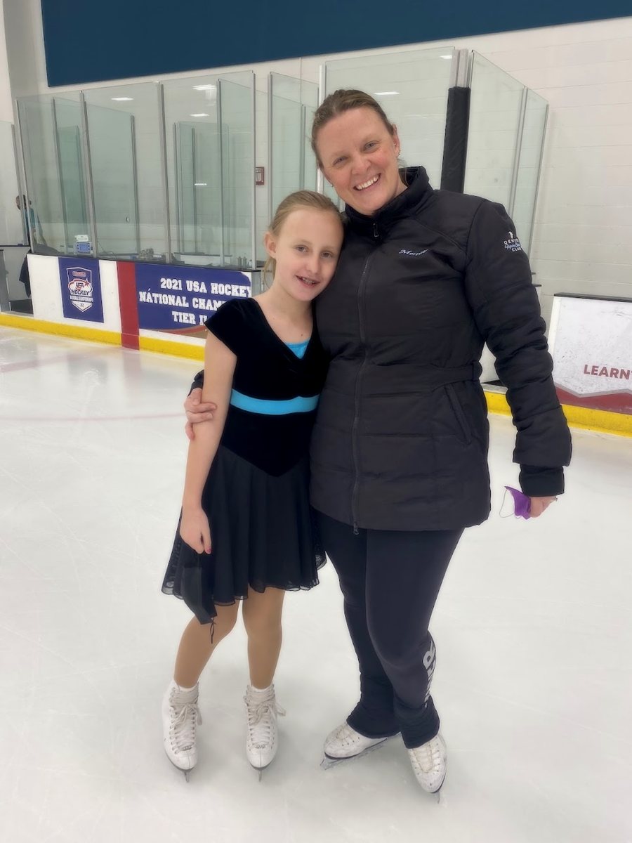 Coach Merrill Prazenka on the ice with a skater